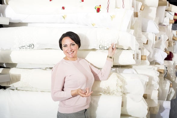 Brunette choosing fabric skeins